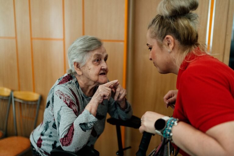 24-hour care at home: caregiver speaking with an older woman at home