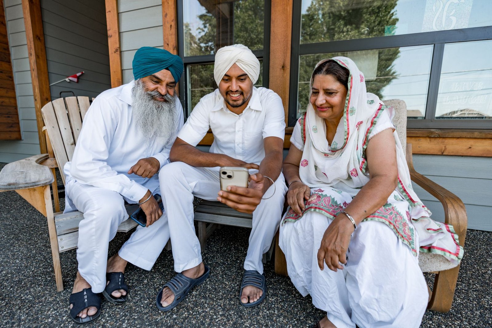 Caring for an elderly parent from a distance, with a family member checking in by video call