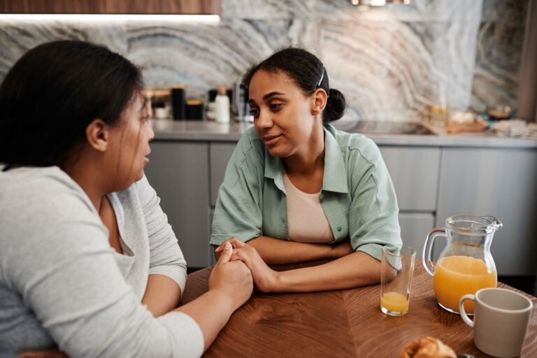 Paying for live-in care with a family discussing arrangements at home